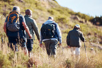 Hiking, field and senior men on mountain for fitness, trekking and backpacking adventure. Explorer, discovery and expedition with friends mountaineering in nature for health, retirement and journey