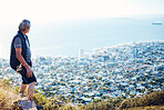 Hiking, explore and senior man with city view for on an adventure, workout and fitness in Cape Town. Training, exercise and elderly person trekking on a mountain for health and wellness