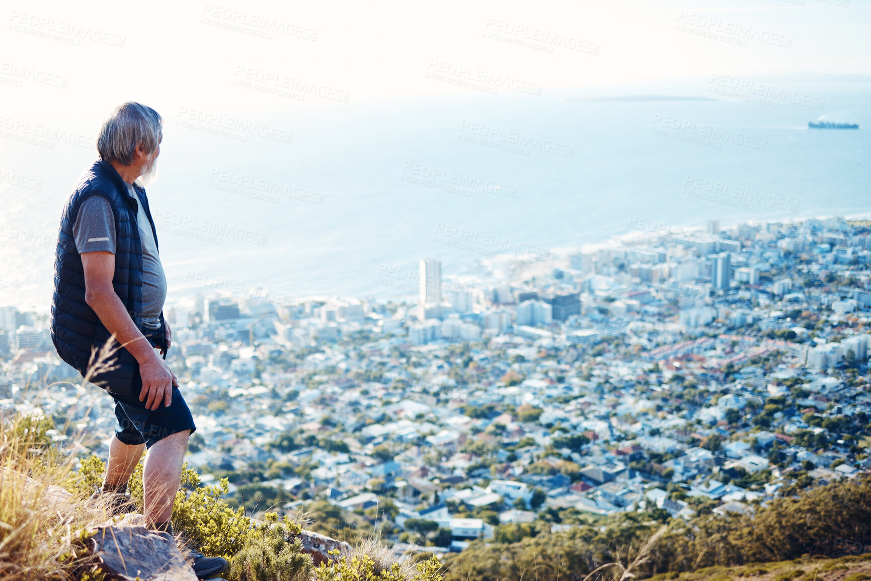 Buy stock photo Hiking, explore and senior man with city view for on an adventure, workout and fitness in Cape Town. Training, exercise and elderly person trekking on a mountain for health and wellness