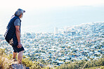 Hiking, looking and senior man explore a city view for on an adventure, workout and fitness in Cape Town. Training, exercise and elderly person search on a mountain for health and wellness