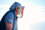 Search, looking and mature man in nature for hiking, travel and holiday to relax on a blue sky. Environment, exercise and elderly Asian person searching on an adventure during a vacation with mockup