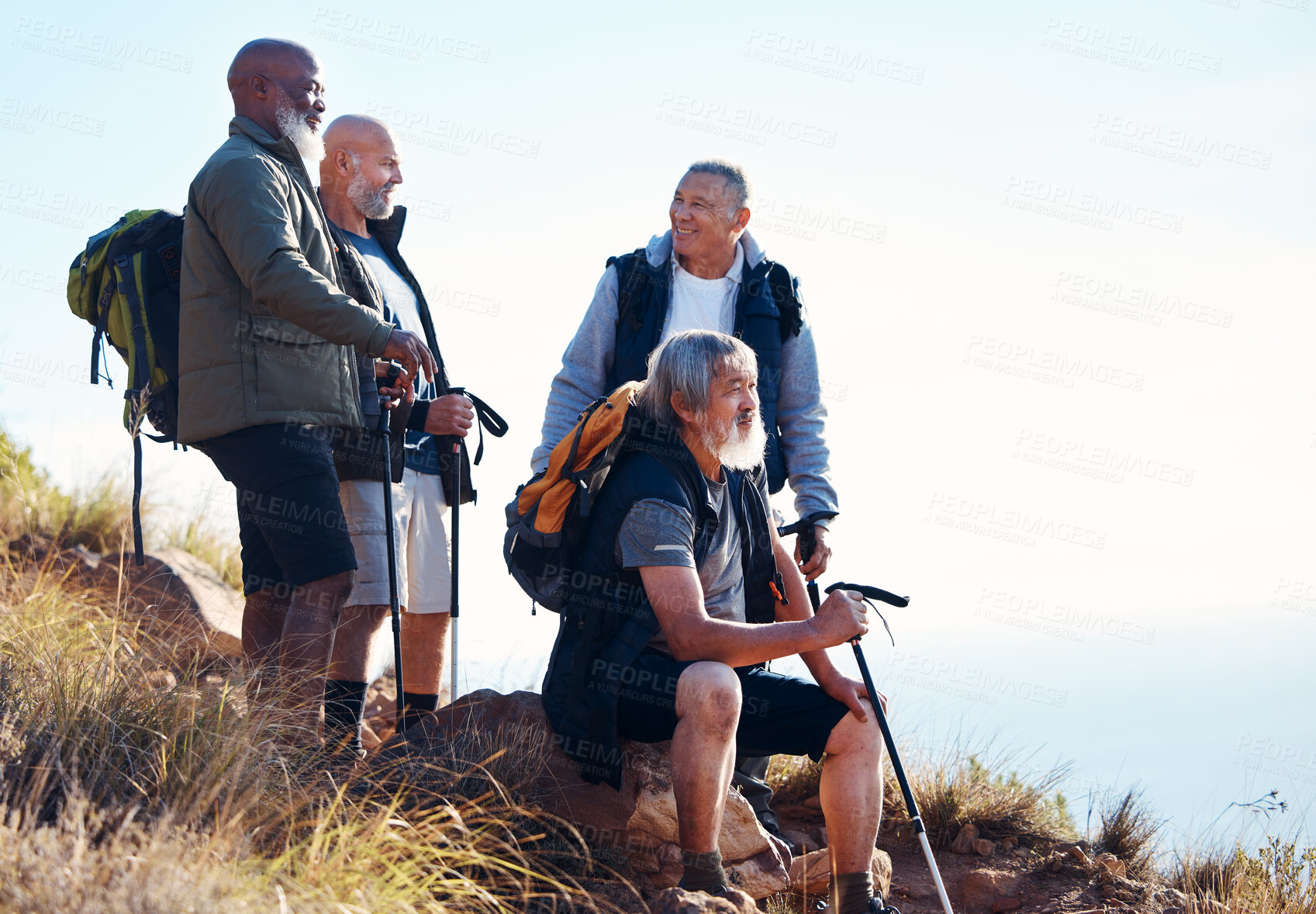 Buy stock photo Senior, men and hiking in nature, relax and calm, sitting and happy on blue sky background. Elderly, friends and man hiker group bond on hill top, freedom and exercise, fitness or retirement activity