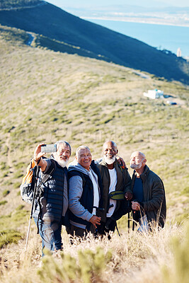 Buy stock photo Senior, men and hiking selfie in nature, happy and relax, cheerful and smile on blue field background. Elderly, friends and man hiker group bond with picture, photo and memory of retirement activity