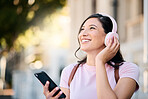 Headphones, happy and music by woman in city for travel, mindset and smile on building background. Radio, podcast and travelling girl student with app, online audio or subscription service outside