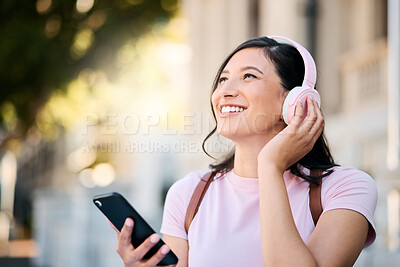 Buy stock photo Headphones, happy and music by woman in city for travel, mindset and smile on building background. Radio, podcast and travelling girl student with app, online audio or subscription service outside