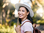 Woman smile, portrait and park walk of a young person happy about nature, travel and freedom. Happiness, backpack and laughing female with blurred background in a garden feeling relax and summer fun