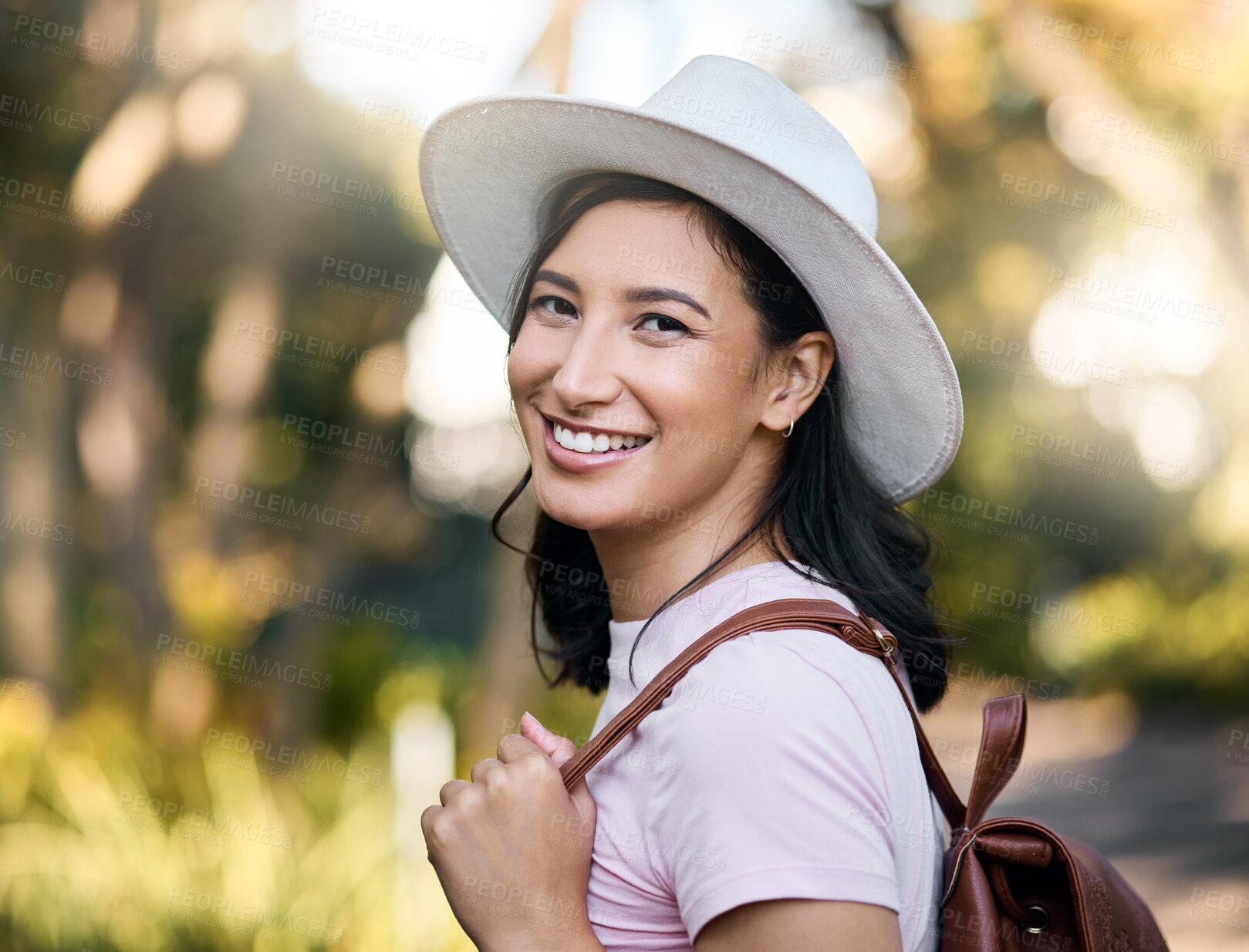 Buy stock photo Woman smile, portrait and park walk of a young person happy about nature, travel and freedom. Happiness, backpack and laughing female with blurred background in a garden feeling relax and summer fun