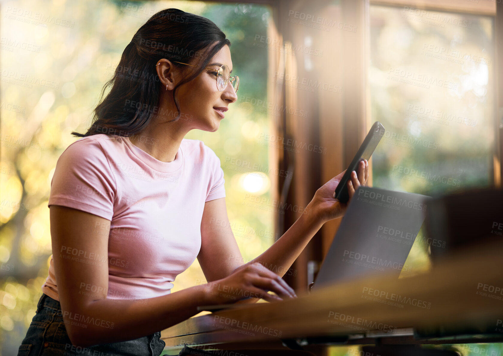 Buy stock photo Research, phone and laptop with woman in cafe browsing for social media, internet and digital. Technology, remote work and contact with girl reading online at table for freelancer, news and planning