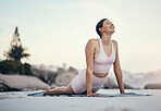Stretching, yoga and woman on a beach floor for wellness, peace and zen, pose and balance on sky background. Meditation, stretch and girl relax with training, energy and peaceful, mindset or workout 