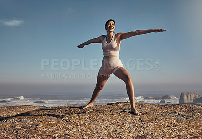 Buy stock photo Happy, balance pose and yoga by woman at a beach for wellness, zen and peace on blue sky background. Smile, standing and meditation by girl at stretch at sea for energy, exercise and fitness workout