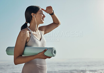 Buy stock photo Fitness, peace and yoga mat by woman at the beach for exercise, balance and cardio on blue sky background. Meditation, training and girl relax at the ocean for wellness, peace and zen at the sea