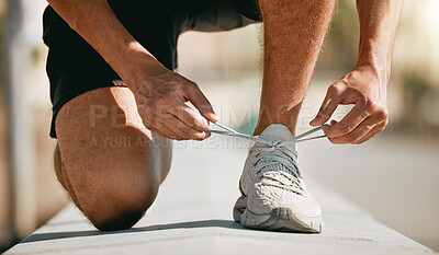 Buy stock photo Fitness, shoes and laces with a man runner getting ready for a cardio or endurance workout closeup outdoor. Exercise, running and workout with a male athlete fastening shoelaces while training 