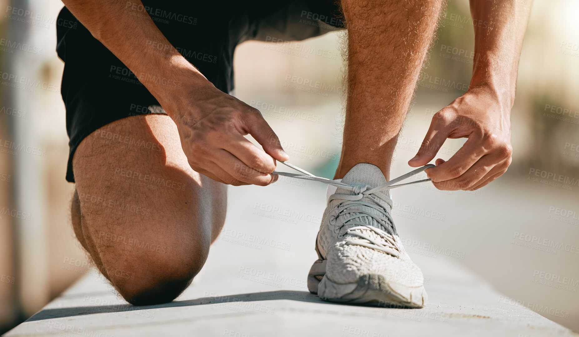 Buy stock photo Fitness, shoes and laces with a man runner getting ready for a cardio or endurance workout closeup outdoor. Exercise, running and workout with a male athlete fastening shoelaces while training 