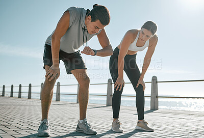 Buy stock photo Tired couple, fitness and exercise time for performance or progress with blue sky at sea outdoor. Woman and man check watch mobile app in nature for workout, running and healthy lifestyle in summer