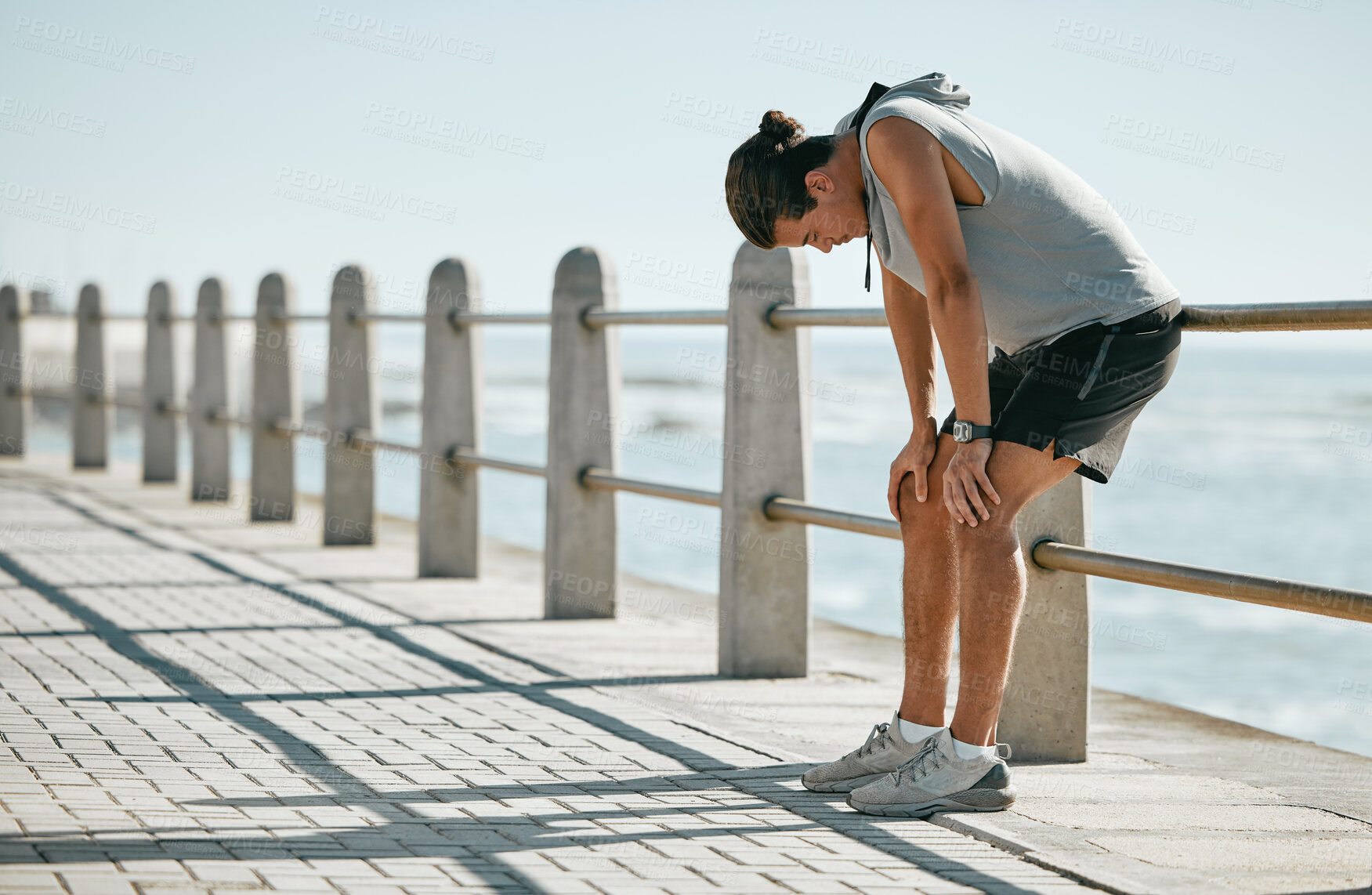 Buy stock photo Fitness, tired and breathing man for cardio training, workout or outdoor running break at beach. Breathe, thinking and fatigue of athlete or sports person with exercise challenge in summer by ocean
