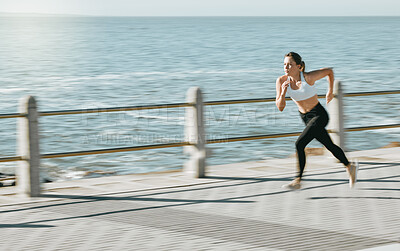 Buy stock photo Woman, fitness and running by beach on mockup for exercise, workout or cardio routine. Active female runner in fast speed run, sprint or race by the ocean coast for healthy exercising in Cape Town
