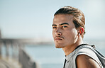 Thinking, fitness and young man at beach for cardio training, workout or running break on blue sky mockup. Calm, mindset and focus of athlete or sports person with exercise journey by ocean or sea