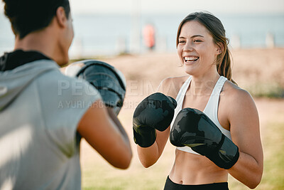 Exercise, happy woman and personal trainer and boxing outdoor at park for fitness, health and wellness. Couple of friends for nature sports workout or fight training with motivation, energy or coach