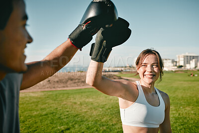 Woman, personal trainer and boxing high five for win, achievement or success outdoor in nature park. Couple of friends happy for sport workout or fight training with motivation, energy and man coach