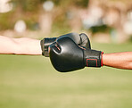 Team, boxing gloves and people fist bump in celebration, collaboration and teamwork in combat sports outdoors. Boxer, hands and friends or fighter training together as workout, exercise and fitness
