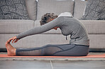 Senior woman, yoga stretching and home on floor for wellness, health and fitness of body in retirement. Elderly lady, workout and training on in living room for healthy muscle, legs and calm mindset