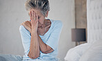 Headache, sick and mature woman with depression, anxiety or mental health problem in the bedroom. Sad, stress and elderly person with insomnia, migraine pain and depressed from fatigue or divorce