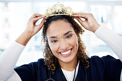 Buy stock photo Portrait, crown or healthcare and a black woman nurse standing in a hospital with a proud smile. Face, happy and award with a female medicine professional posing as a winner in a medical clinic