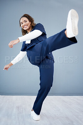 Buy stock photo Kick, healthcare and black woman with celebration, achievement and grey studio background. Portrait, Jamaican female and medical professional with leg in air for happiness, promotion and employee