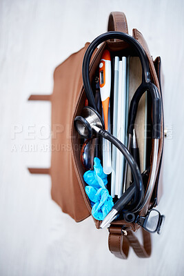 Buy stock photo Top view, doctor bag and clinic with stethoscope, books and glasses on desk for job in medical industry. Doctors, nurse or medic tools in leather case for healthcare, wellness and help at hospital