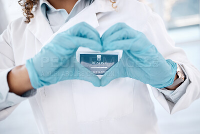 Buy stock photo Closeup, hands and dentist with heart, woman and health for wellness, care and support. Love sign, zoom and female medical professional for dental hygiene, solidarity and innovation with blue gloves
