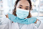 Portrait, covid and cute with a black woman nurse in the hospital, wearing a mask for health and safety. Face, medical and healthcare with a female medicine professional posing closeup in a clinic