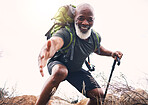 Hiking, help and portrait of senior man reaching hand during hike, fitness and cardio in nature on light background. Helping, hands and face of elderly guy offering support while trekking in a forest