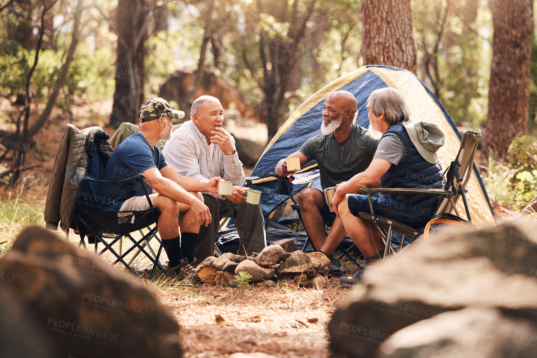 Buy stock photo Senior people, camping and relaxing in nature for travel, adventure or summer vacation together on chairs by tent in forest. Group of elderly men talking, enjoying camp out conversation in the woods