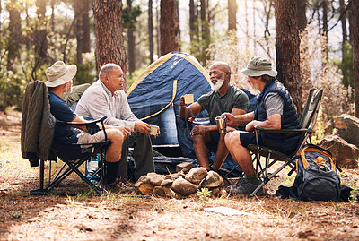 Buy stock photo Man, friends and camping in nature with coffee for travel, adventure or summer vacation together on chairs by tent in forest. Group of men relaxing, talking or enjoying natural camp by trees outdoors