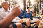 Camping, trekking and senior men in nature enjoying drink for toasting in retirement celebration or travel. Elderly friends raising cup on camp chairs for friendship adventure in the forest woods