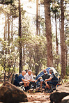 Man, people and camping in nature for travel, adventure or summer vacation together with chairs and tent in forest. Group of men relaxing and talking enjoying camp out by tall green trees in outdoors