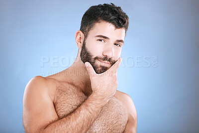 Buy stock photo Skincare, portrait of man and hand on beard, confidence and face cleaning treatment isolated on blue background. Facial hygiene, male model grooming shave and health, wellness and skin care in studio