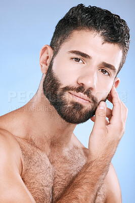 Buy stock photo Skincare, portrait of man with beard and hand on face, morning cleaning treatment isolated on blue background. Facial hygiene, male model and grooming shave, health, wellness and skin care in studio.