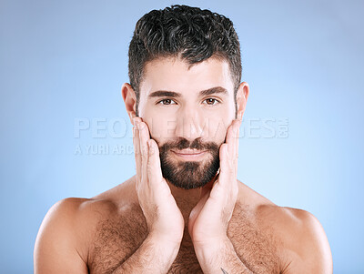 Buy stock photo Skincare, face and portrait of man with hand on beard, morning cleaning treatment isolated on blue background. Facial hygiene, male model and grooming hair health, wellness and skin care in studio.