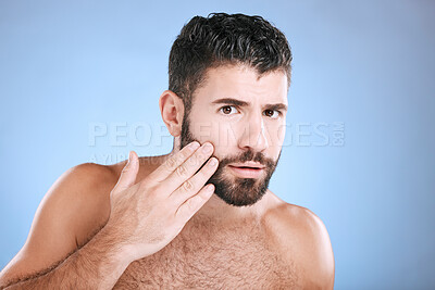 Buy stock photo Skincare, beard grooming and portrait of man on blue background for beauty, wellness and salon. Luxury spa, dermatology and worried male check face for healthy skin, blackhead and facial hair growth