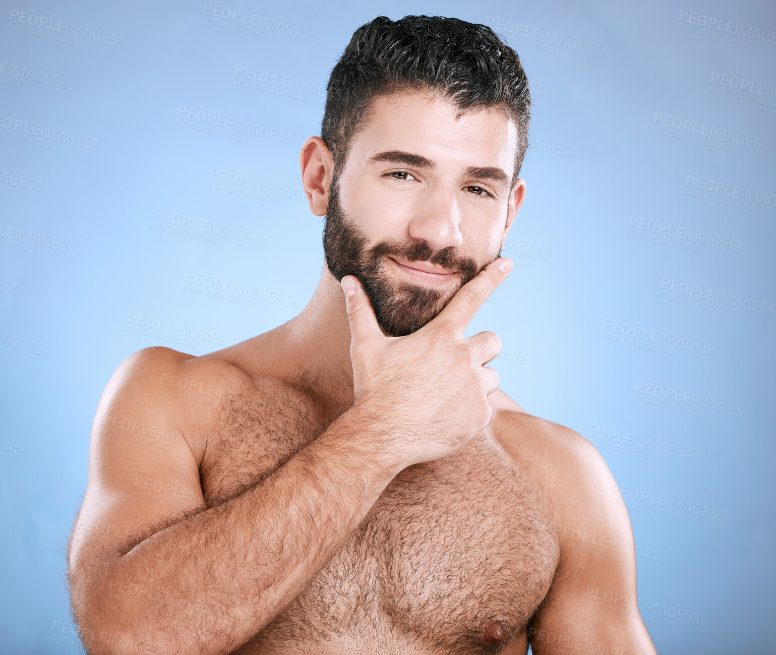 Buy stock photo Skincare, beauty and portrait of man with beard, hand on face and cleaning treatment isolated on blue background. Facial hygiene, happy male model and grooming health, smile and hair care in studio.