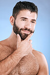Idea, beauty and skincare with a man model in studio on a blue background for natural wellness or grooming. Face, beard and skin with a handsome young male thinking about cosmetics or treatment