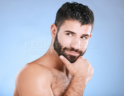 Buy stock photo Idea, beauty and wellness with a man model in studio on a blue background for natural skincare or grooming. Face, beard and skin with a handsome young male thinking about cosmetics or treatment