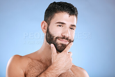Buy stock photo Idea, beauty and grooming with a man model in studio on a blue background for natural wellness or skincare. Face, beard and skin with a handsome young male thinking about cosmetics or treatment