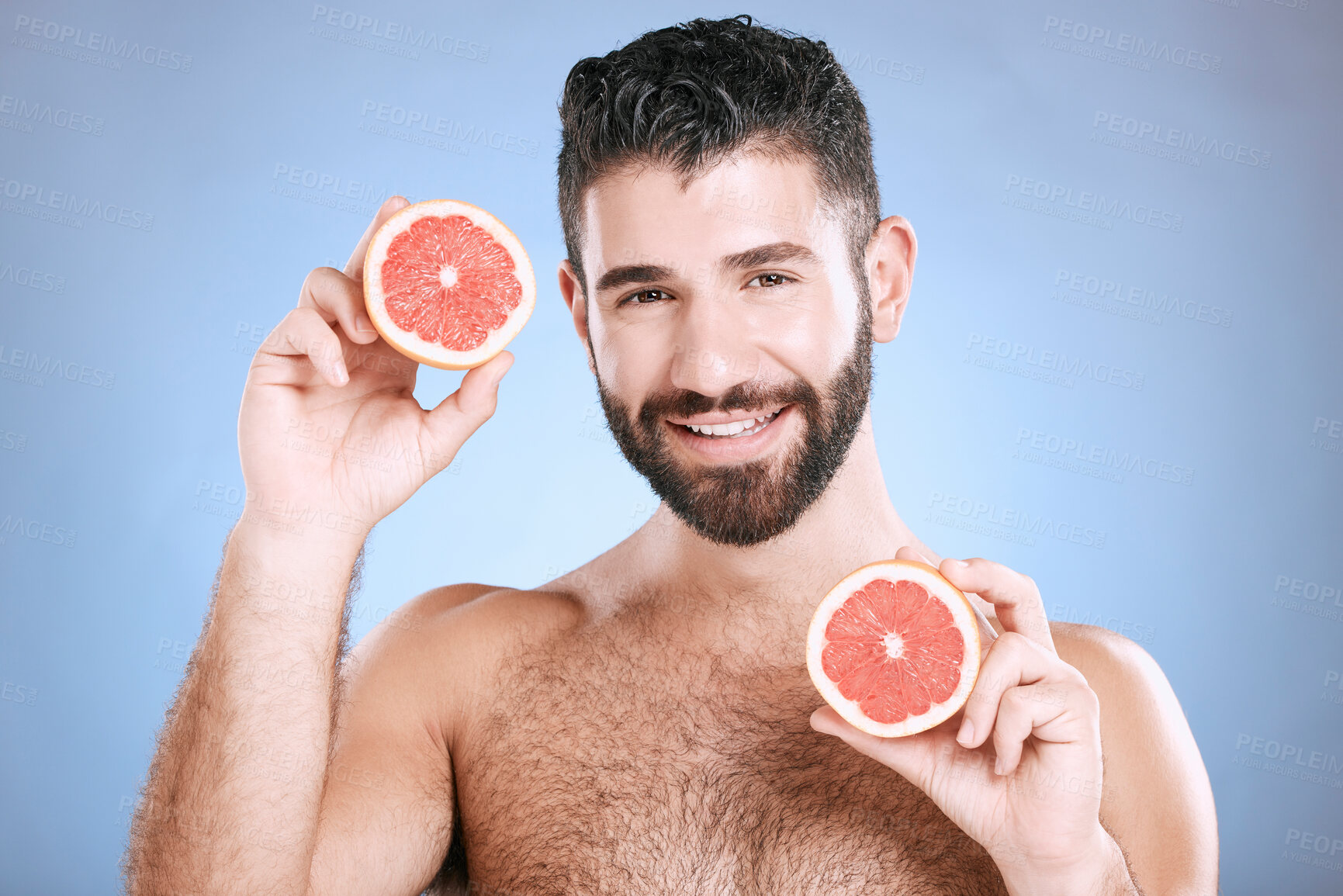 Buy stock photo Portrait, skincare and grapefruit with a man model in studio on a blue background for natural beauty or hygiene. Fruit, wellness and nutrition with a handsome male posing to promote a healthy diet