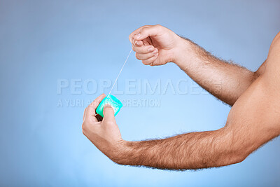 Buy stock photo Floss, dental and man hands with container on studio mockup for teeth, mouth cleaning and marketing. Closeup of flossing product, thread and blue background for tooth cosmetics, mock up and backdrop