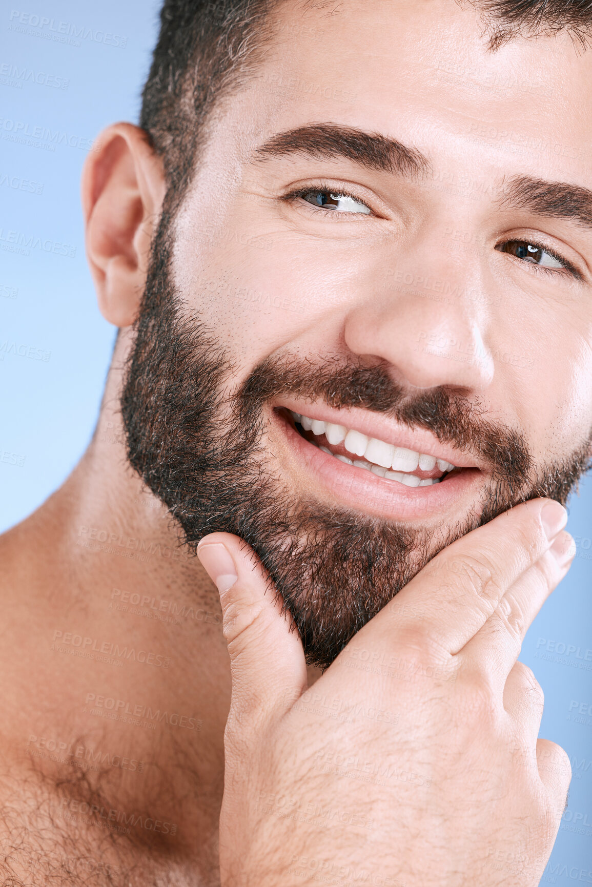 Buy stock photo Face, beauty and skincare with a man model in studio on a blue background for natural wellness or grooming. Idea, beard and skin with a handsome young male thinking about cosmetics or treatment