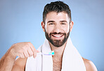 Toothbrush, portrait and man cleaning in studio for dental wellness, healthy smile and mouth. Happy male model brushing teeth, face and care of fresh breath, oral gums or dentistry on blue background