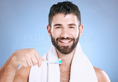 Buy stock photo Toothbrush, portrait and man cleaning in studio for dental wellness, healthy smile and mouth. Happy male model brushing teeth, face and care of fresh breath, oral gums or dentistry on blue background