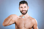Teeth, toothbrush and portrait of man in studio for dental wellness, healthy smile and mouth care. Happy face, male model and oral cleaning for fresh breath, gums and dentistry on blue background 